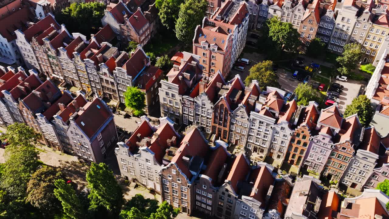 Drone tilt over colorful Gdansk houses symbolizing Europe’s peace and tension