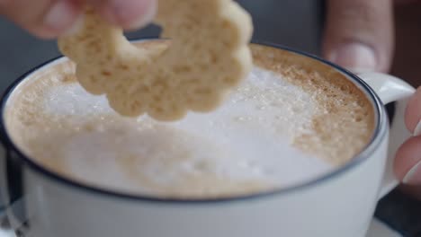 dipping a cookie into coffee