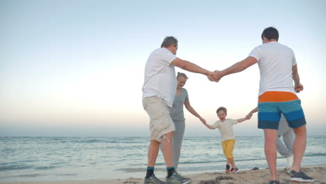 Family-circle-dancing-on-the-coast