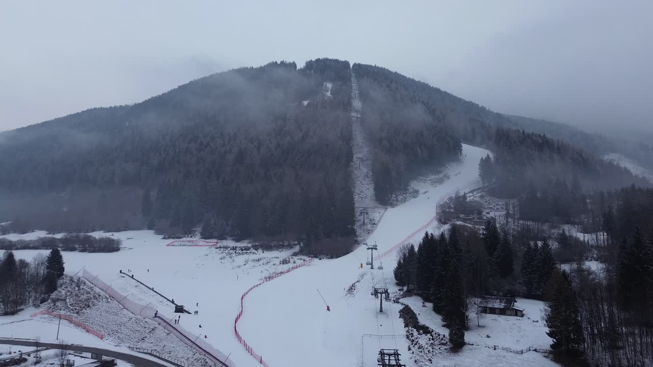 This is a large ski area that prepares Cortina 2026 in Italy. The locations are captured with a drone that shows the beauty of winter sports that combine blue sky, white snow and smells forest