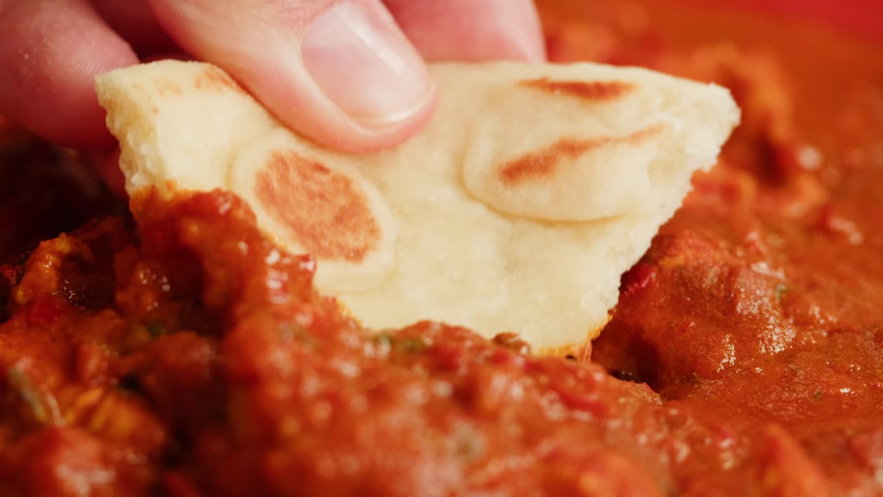 A vibrant platter featuring a variety of traditional Indian dishes, including curries, chutneys, and flatbreads.