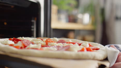 placing baking sheet with pizza into oven