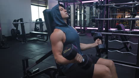 Caucasian-Athletic-Sportsman-Doing-Bicep-Curls-with-Heavy-Dumbbell-Weights-Seated-on-Bench---static-shot-4k60fps