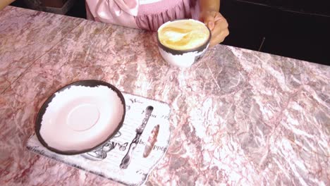 barista making a latte in a coffee shop