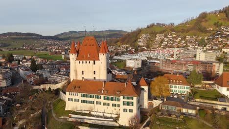 medieval thun castle stronghold towering over town center, switzerland