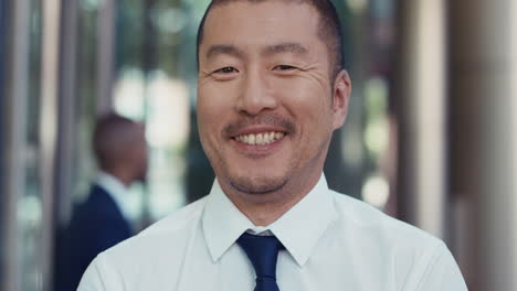 portrait of japanese businessman outside corporate office building