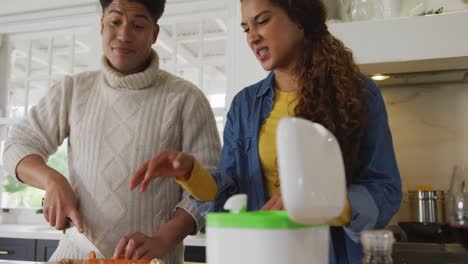 Video-of-happy-biracial-couple-preparing-meal-together