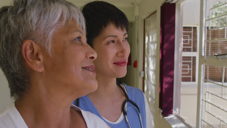 nurse helping a senior woman in a retirement home