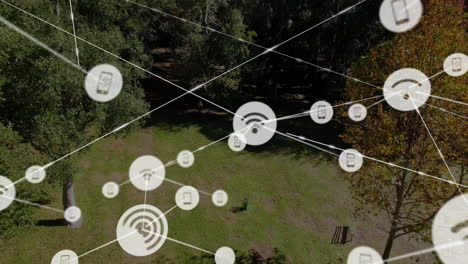 network connectivity icons animation over aerial view of forested area