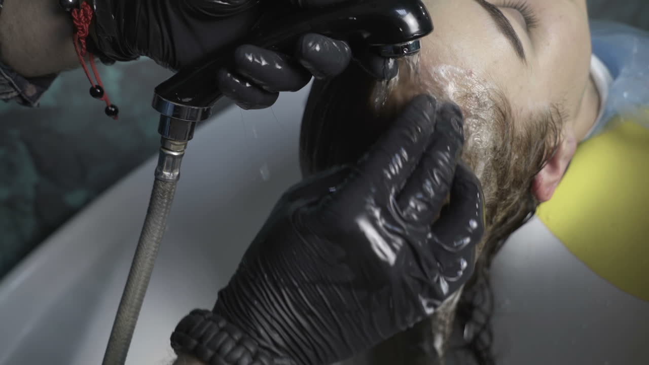 Hairdresser dying female hair. Woman client hair in beauty parlour hairdressing salon