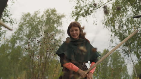 teenage girl holding spear defeats enemy smiling gladly