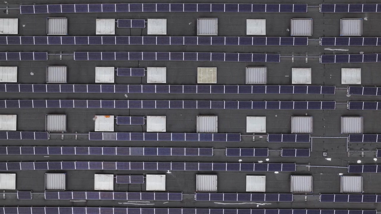 Ripresa con drone di energia solare decentralizzata. Pannelli solari sul tetto di un magazzino