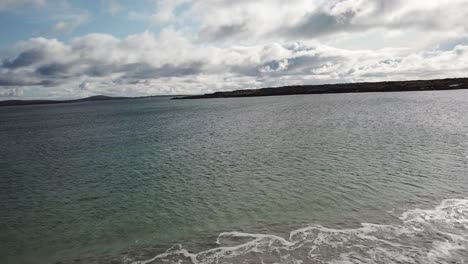 aerial-push-in:-atlantic-ocean-in-Connemara,-Ireland,-sunny-day