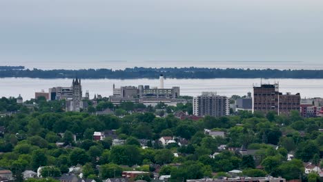 panoramic cityscape with lush green trees and waterfront