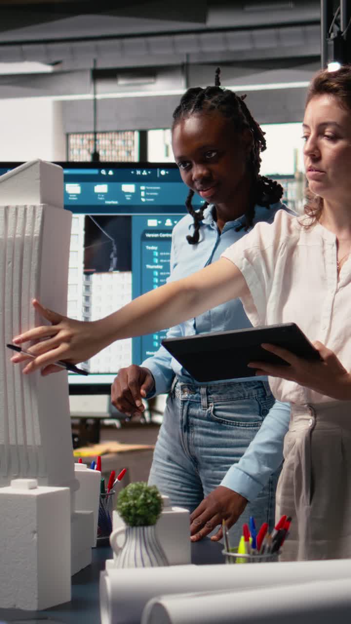 Vertical Video Diverse female contractors sharing structural layout ideas for residential area