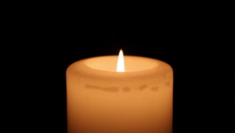 hands being warmed by a candle flame