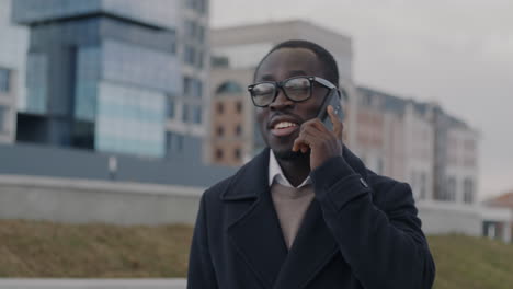 man talking on phone in city