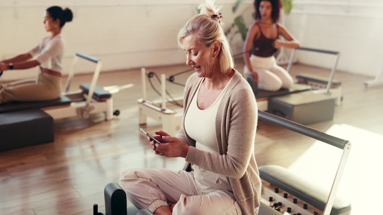 Pilates class with women exercising on reformers