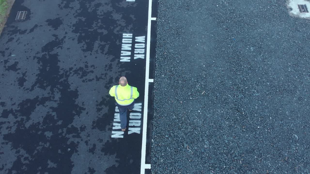 Labour worker walking to work with dignity aerial