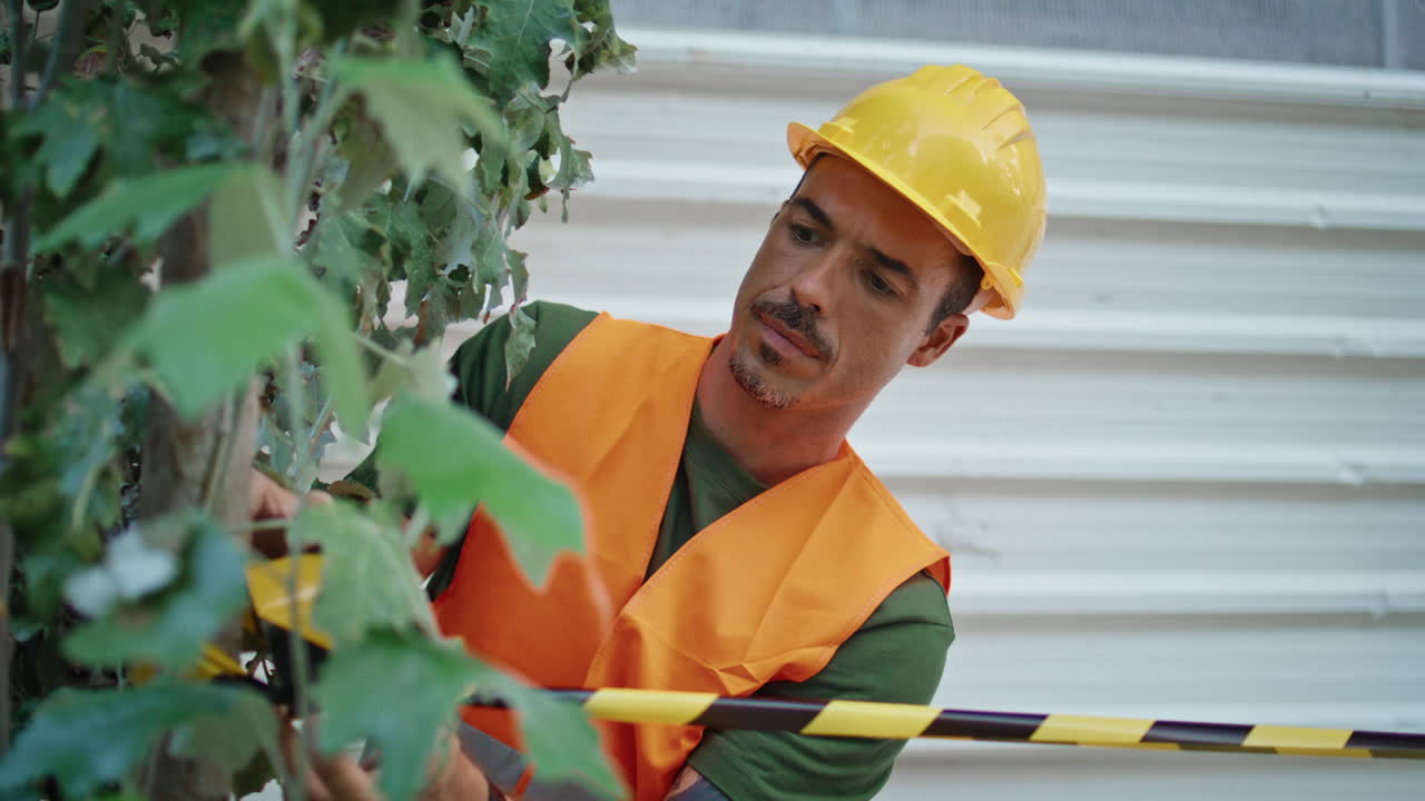 Serious builder putting warning stretch at morning town closeup. Man working