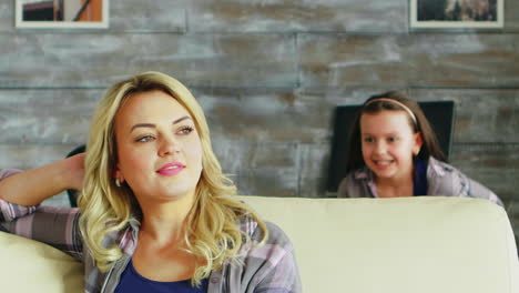 slow motion shot of adorable daughter hugging her mother from behind