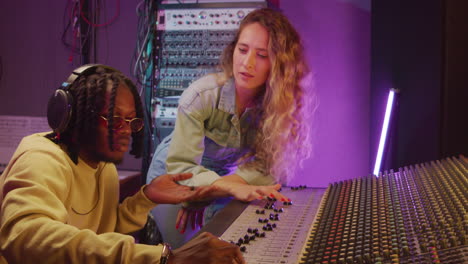 multiethnic colleagues recording music in studio