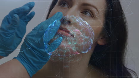 clinician placing blue gloves on client face, projecting medical brain hologram with grid overlay