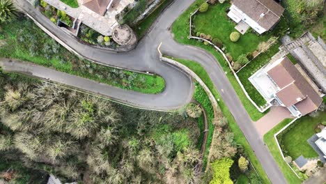 Guernsey-Fort-George-overhead-footage-of-cliff-top-houses-on-one-of-Guernsey’s-most-expensive-housing-estates-showing-open-market-houses-gardens-cliffs-cove-and-surrounding-area-on-bright-sunny-day