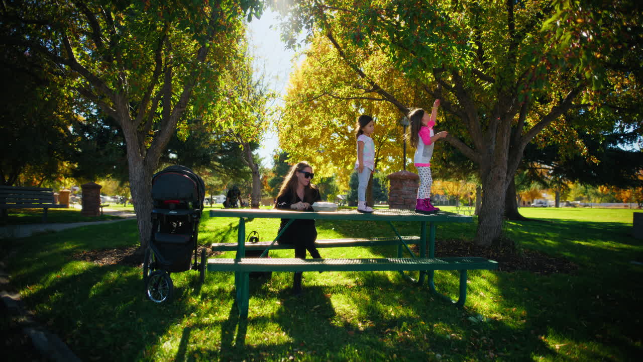 Mother and daughters enjoying a sunny afternoon in the park