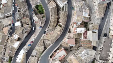 tiny cars curves through the amazing narrow streets of ragusa