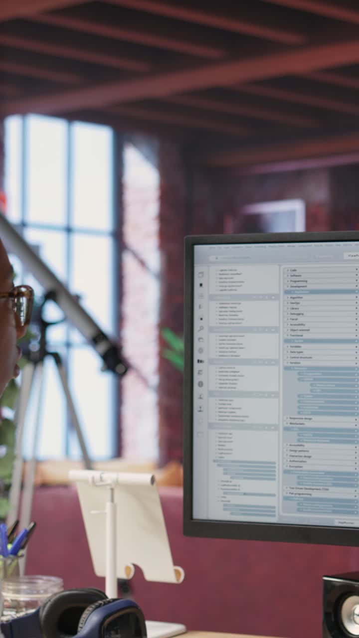 Vertical video System administrator types code into PC, developing software