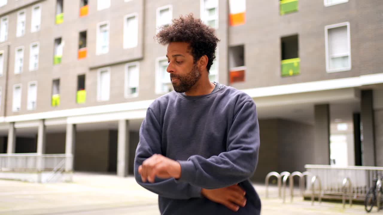 Man Performing Hand Gestures in Urban Setting