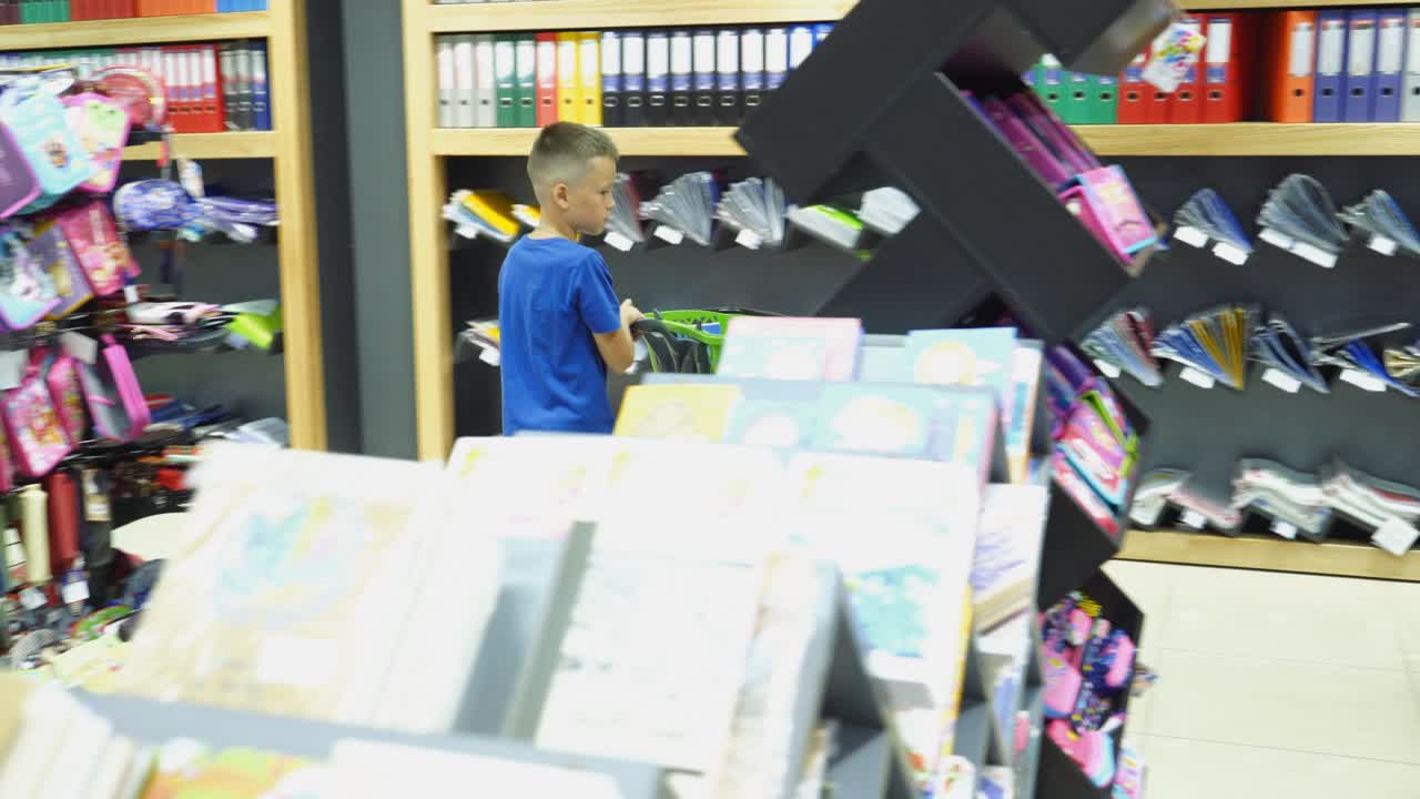 VINNITSA, UKRAINE - AUGUST 20, 2018: Boy choosing buying stationery in store preparing for first day in school. Back to school concept.