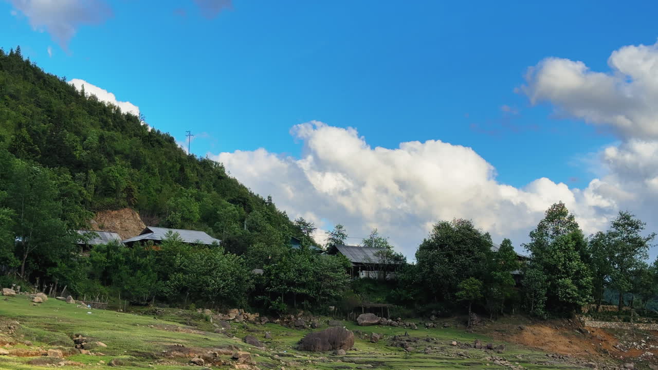 Scenic view of mountain and small cabin nestled in lush green natural surroundings
