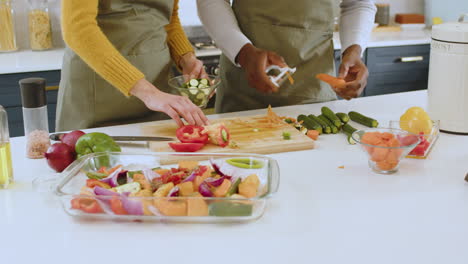 Multiracial couple preparing fresh vegetables together in kitchen, enjoying cooking at home, at home