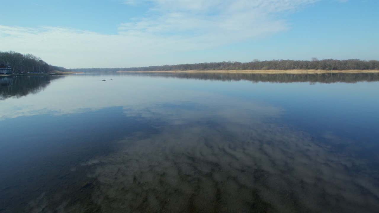 extra Wide shot of Rollesby Broad with sky reflecting in the water taken from the A149 at Ormesby St Margaret