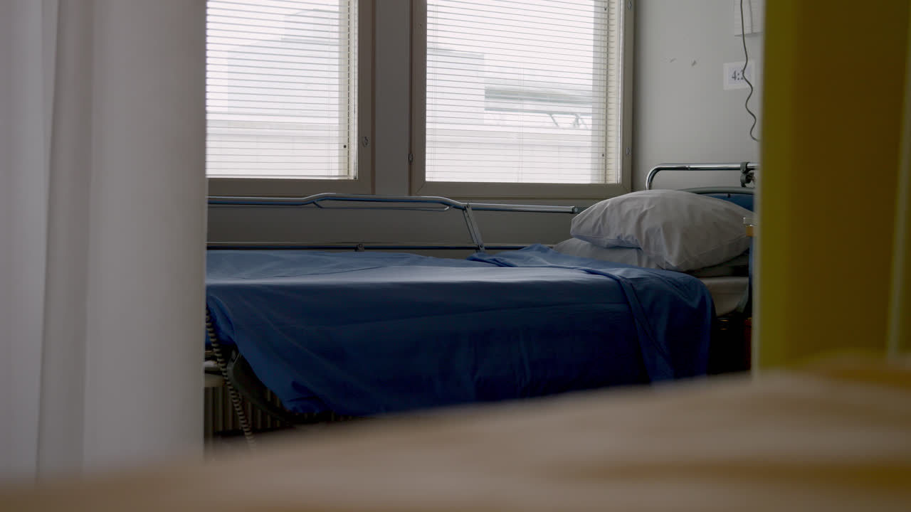 video of empty hospital bed behind curtains