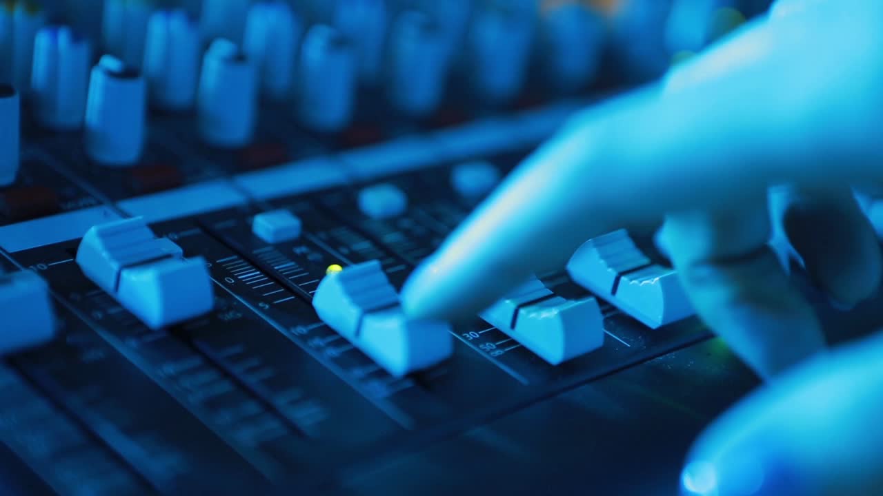 Expert Adjusting Audio Mixing Console. Audio mixer mixing board fader and knobs
