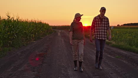 farmers walking along a country road at sunset