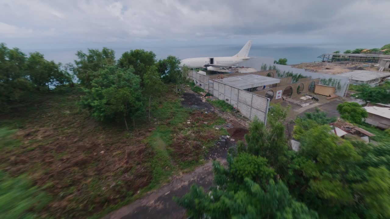 fpv 드론은 발리의 절벽 위에 있는 만다라 항공 비행기 호텔의 총상을 날고 있습니다.