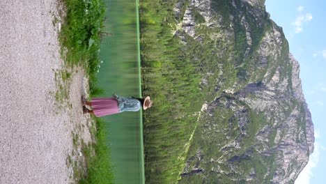 Lady-in-pink-dress-standing-near-Lago-di-Landro