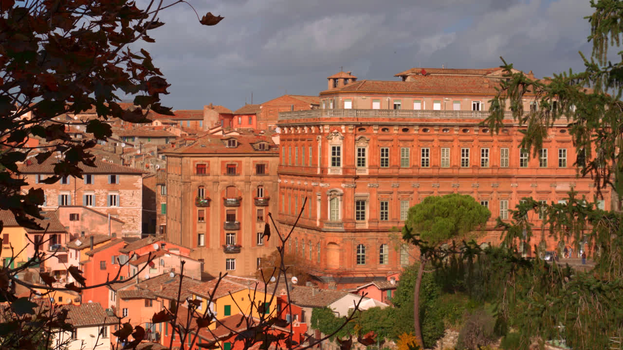 Panoramic view of old town buildings in Perugia bathed in warm evening sunlight