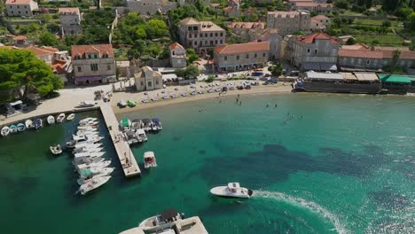 aerial reveal of a boat entering lopud harbor