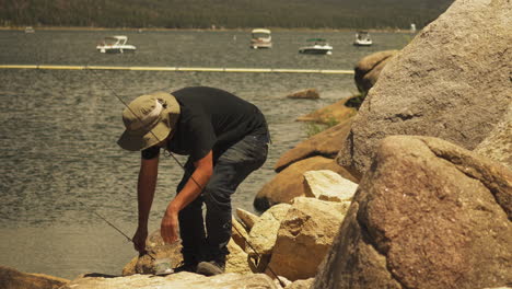 fisherman frustrated kneeling to put the bait on the fishing line