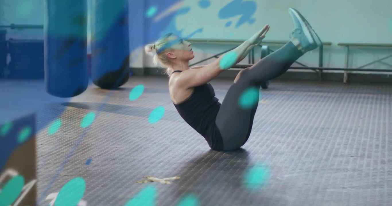 Vertical video: Starting flat, woman in gym wear doing V-ups on mat for core, with bags, overlays