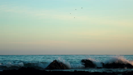 waves hitting the rocks at dusk