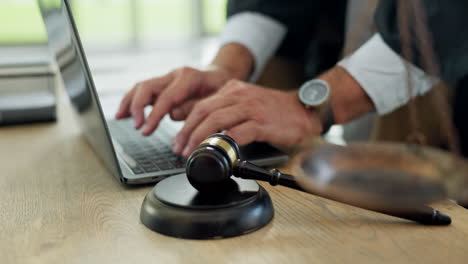 Law,-gavel-and-hands-typing-on-a-laptop