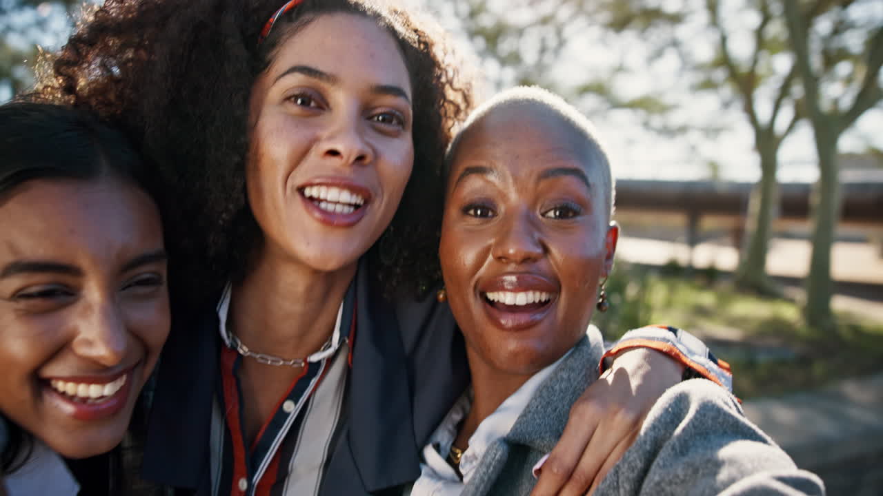Two Women Smiling and Embracing Outdoors