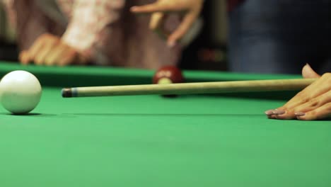 many friends joyfully play billiards.