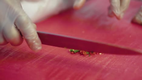 cook-chops-the-chili-pepper-for-the-salad